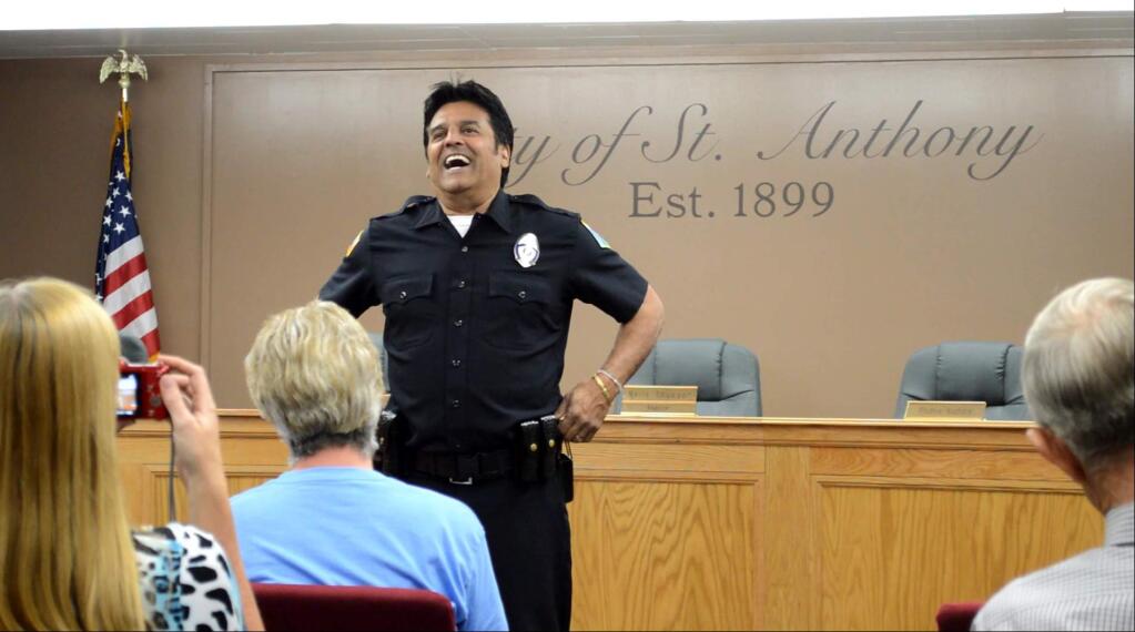 In this Saturday, July 2, 2016, photo famed 'CHiPs' police officer Erik Estrada mets St. Anthony residents to discuss his efforts with the St. Anthony Police Department to stop internet enticement of children at St. Anthony City Hall. Estrada has spent the past decade working with various law enforcement departments to keep kids safe online. Following his induction Estrada as a now a St. Anthony Police Department reserve officer, he told how important it is to teach children what not to do while on the web. (Lisa Dayley-Smith/Rexburg Standard Journal via AP) MANDATORY CREDIT