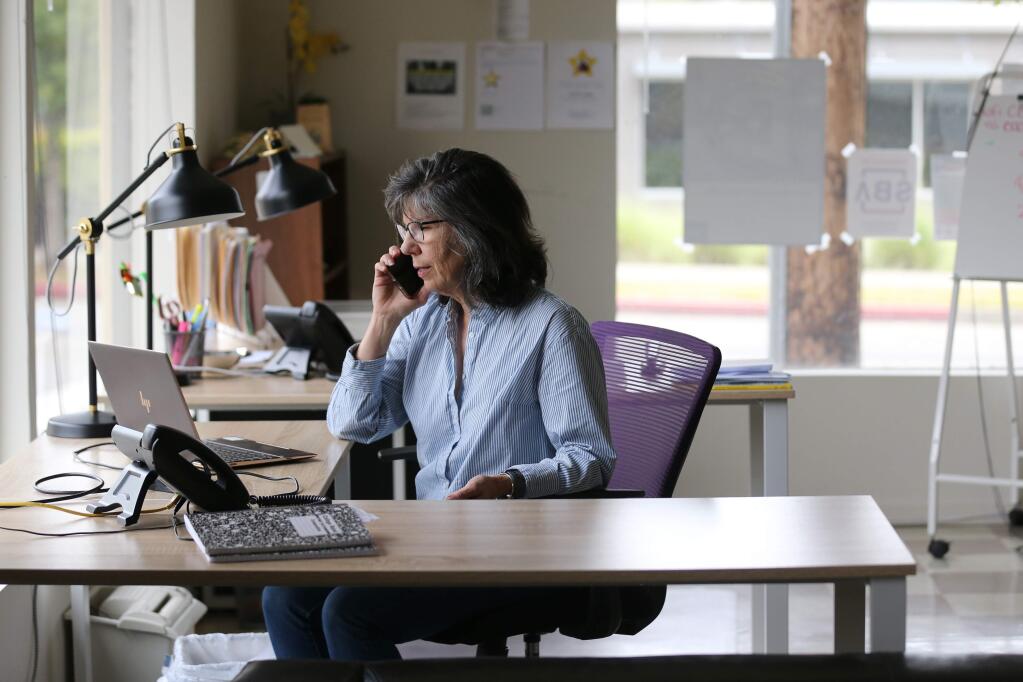 Mary Anne Petrillo, CEO of West Business Development Center, takes a phone call in the office in Ukiah, California on Wednesday, May 13, 2020. (BETH SCHLANKER/ The Press Democrat)