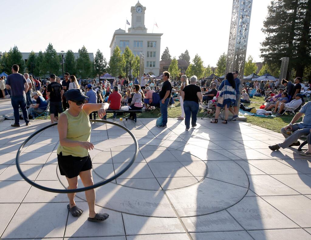 Downtown Santa Rosa’s Summer on the Square event sereis brings local bands, popular movies and other events, such as the Wednesday Night Market, to Old Courthouse Sqaure. In this file photo, Choi Tse of Santa Rosa uses a hula hoop while she grooves to live music during the last Wednesday Night Market of the season at Old Courthouse Square, in Santa Rosa, California, on Wednesday, August 28, 2019. (Alvin Jornada / The Press Democrat)