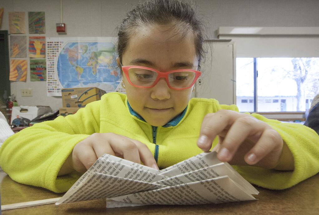 Artists Kate Ortolano and Gayle Manfre introduced El Verano students to the wonderful world of book art, which starts with learning how to fold pages of a bound book into a pleasing design. The students' books will later be assembled into an installation that will be displayed in the school library. Here, fourth-grader Joselyn Perez-Chavez focuses on a specific folding technique. Sponsors of the artistic endeavor were Plein air and The Friends of the Library, who supplied the books. (Photos by Robbi Pengelly/Index-Tribune)