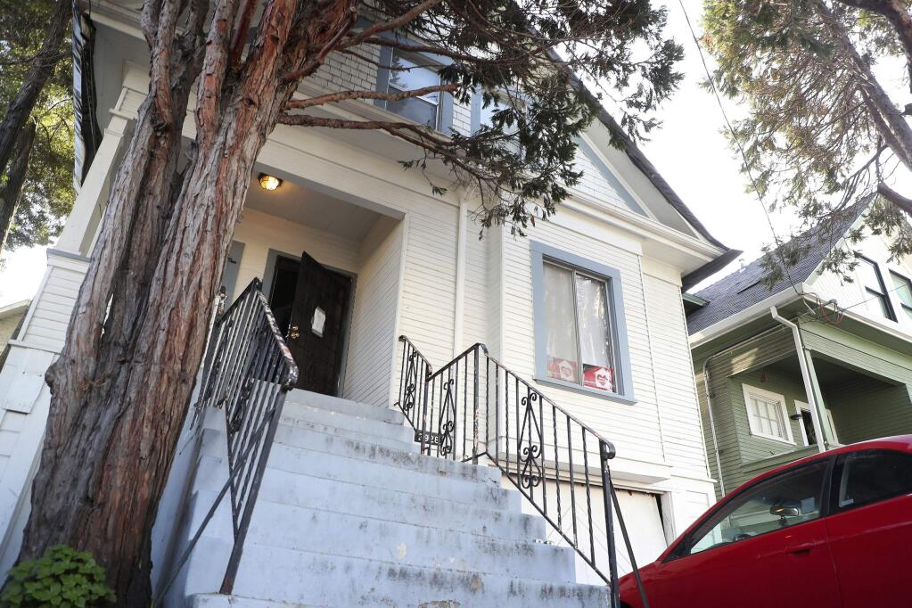 In this photo taken Dec. 24, 2019, is a home along Magnolia Street that is being occupied by the group Moms 4 Housing in West Oakland, Calif. The women took over the home after they said they were unable to find permanent housing in the Bay Area, where high-paying tech jobs have exacerbated income inequality and a housing shortage. They also say they're protesting real estate developers who snap up distressed homes, then leave them empty. (Aric Crabb/Bay Area News Group via AP)