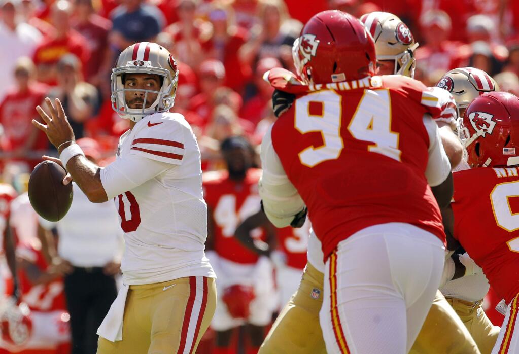 San Francisco 49ers quarterback Jimmy Garoppolo (10) prepares to throw a touchdown pass to wide receiver Marquise Goodwin during the first half of an NFL football game against the Kansas City Chiefs in Kansas City, Mo., Sunday, Sept. 23, 2018. (AP Photo/Charlie Riedel)