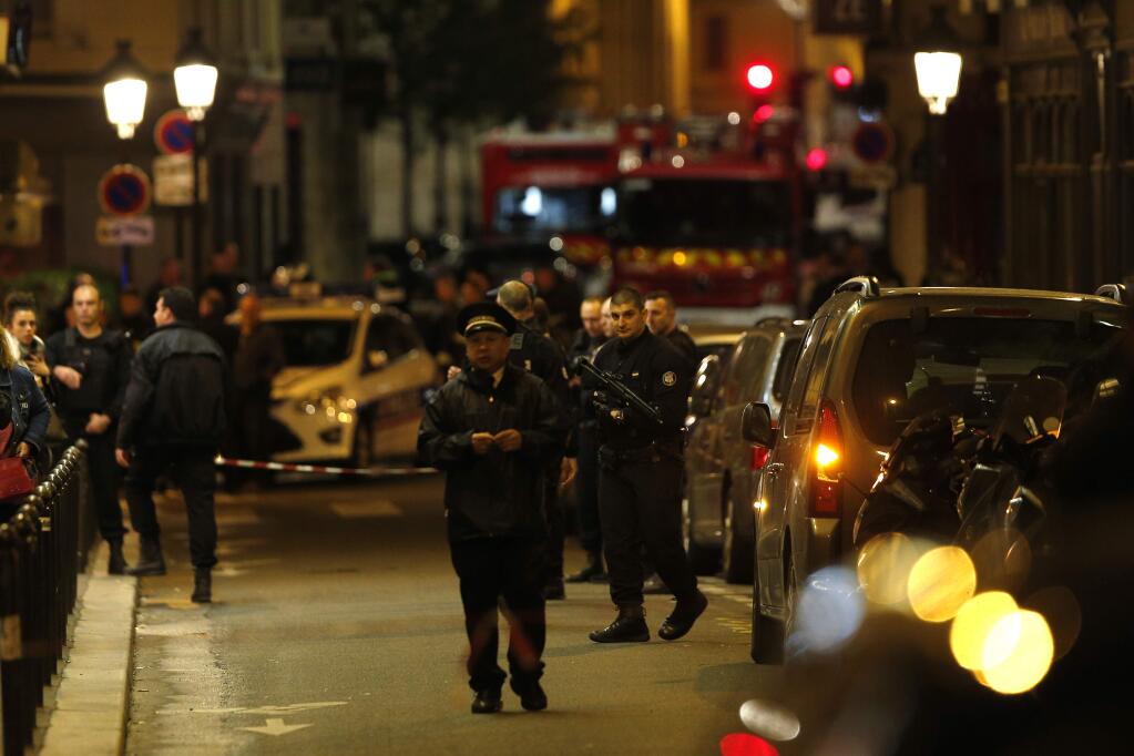 Police officers secure the area after a knife attack in central Paris, Saturday May 12, 2018. The Paris police said the attacker was subdued by officers during the stabbing attack in the 2nd arrondissement or district of the French capital Saturday. (AP Photo/Thibault Camus)
