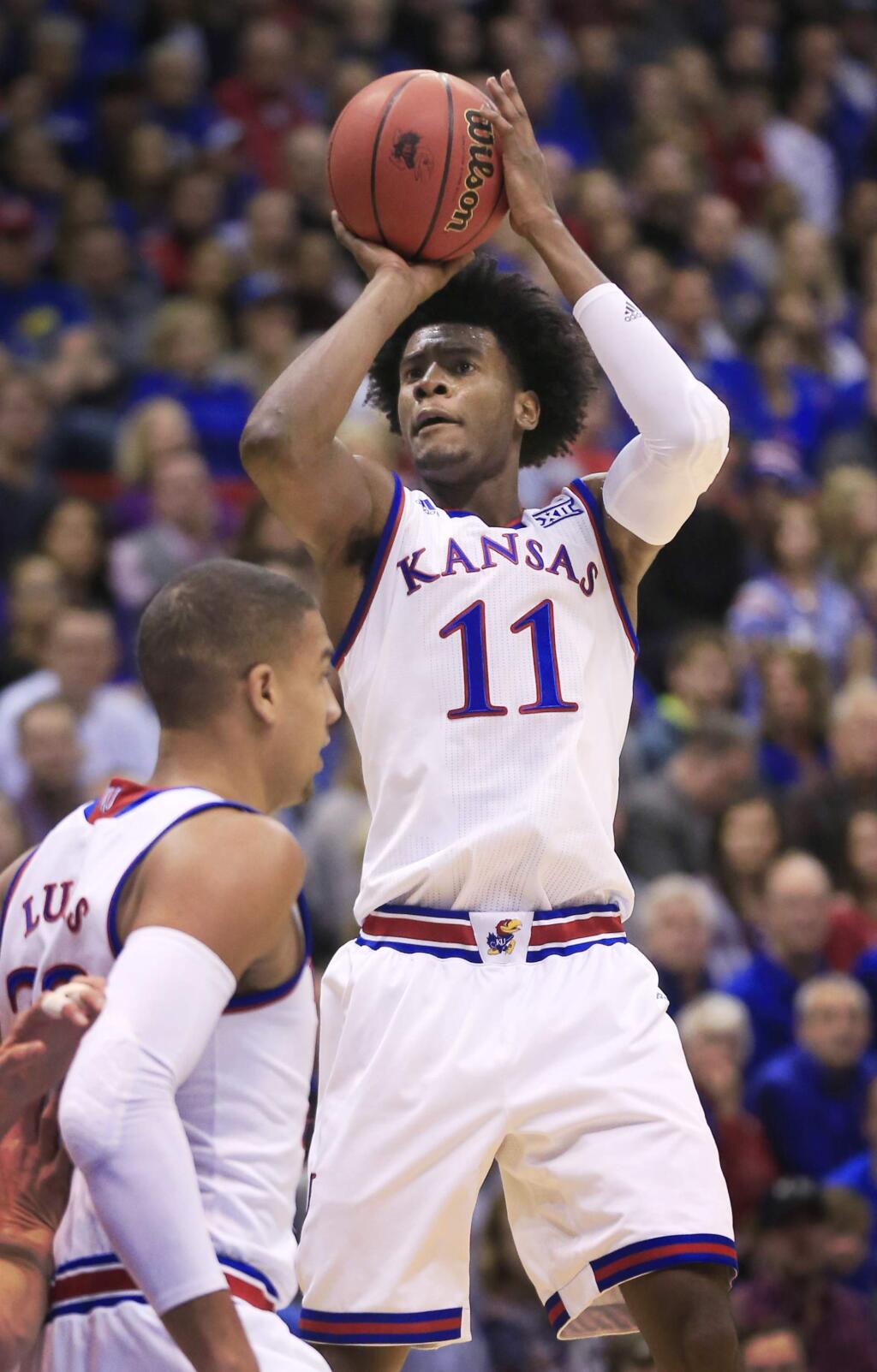Kansas guard Josh Jackson (11) shoots a basket during the first half of an NCAA college basketball game against Nebraska in Lawrence, Kan., Saturday, Dec. 10, 2016. Jackson scored 17 points in the game. Kansas defeated Nebraska 89-72. (AP Photo/Orlin Wagner)