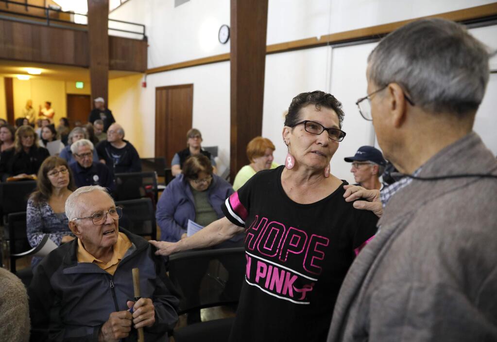 Journey's End Mobile Home Park residents Sam Willis, left, Pat Burke, center, and Victor Oteri talk before a meeting with members of local and federal government in order to discuss the plans for asbestos testing and mitigation. Photo taken at the Steele Lane Community Center on Sunday, November 5, 2017 in Santa Rosa, California . (BETH SCHLANKER/The Press Democrat)