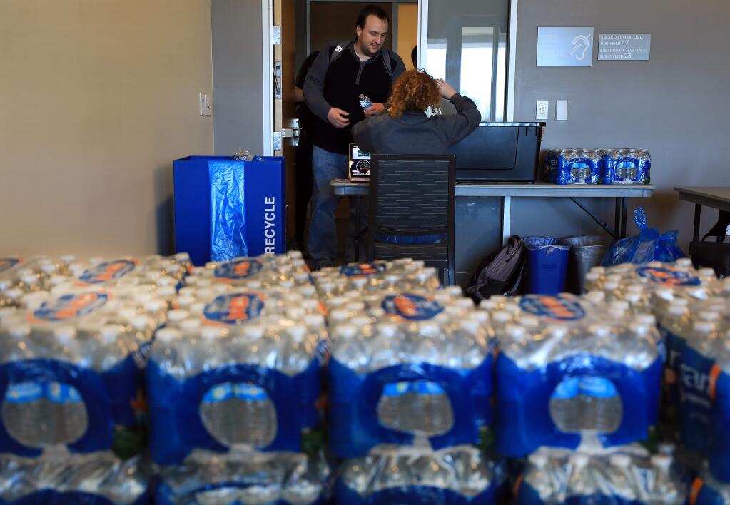 Sonoma State University senior Morganne Schmidt gives out water, one bottle at a time to SSU students, Tuesday, April 9, 2019 at the student center. A malfunctioning water system prompted school officials to urge students to drink bottled water or boiled tap water until the problem is alleviated. (Kent Porter / Press Democrat) 2019