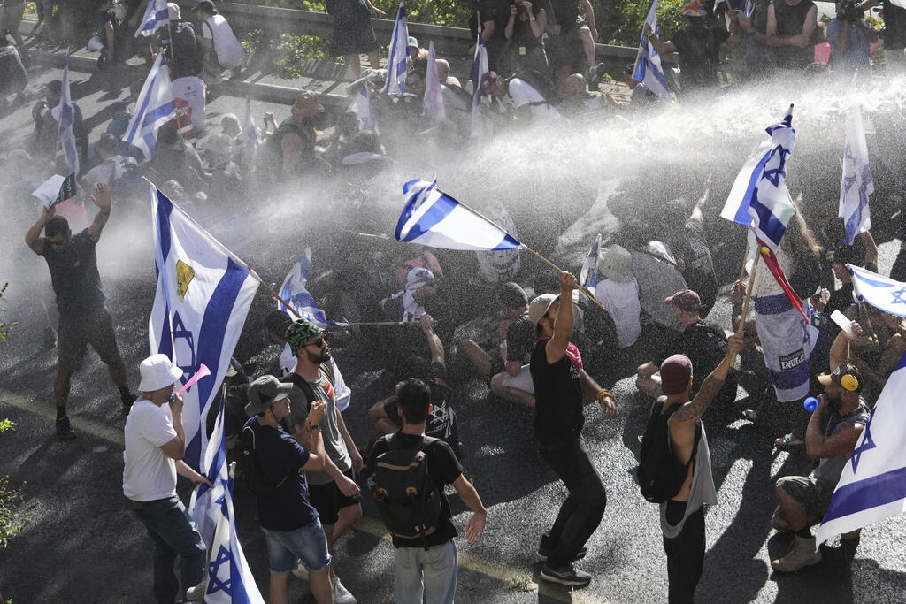 Israeli police use a water cannon to disperse demonstrators during a protest Monday against Prime Minister Benjamin Netanyahu’s overhaul of the judicial system. (MAHMOUD ILLIAN / Associated Press)