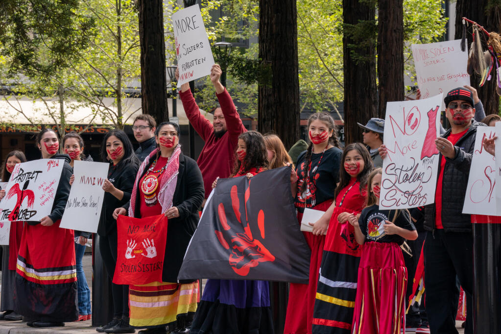 Community members wave flags and signs in front of Old Courthouse Square to raise awareness of Missing and Murdered Indigenous Women and Persons in Santa Rosa, Saturday, May 6, 2023. (Nicholas Vides / For The Press Democrat file)