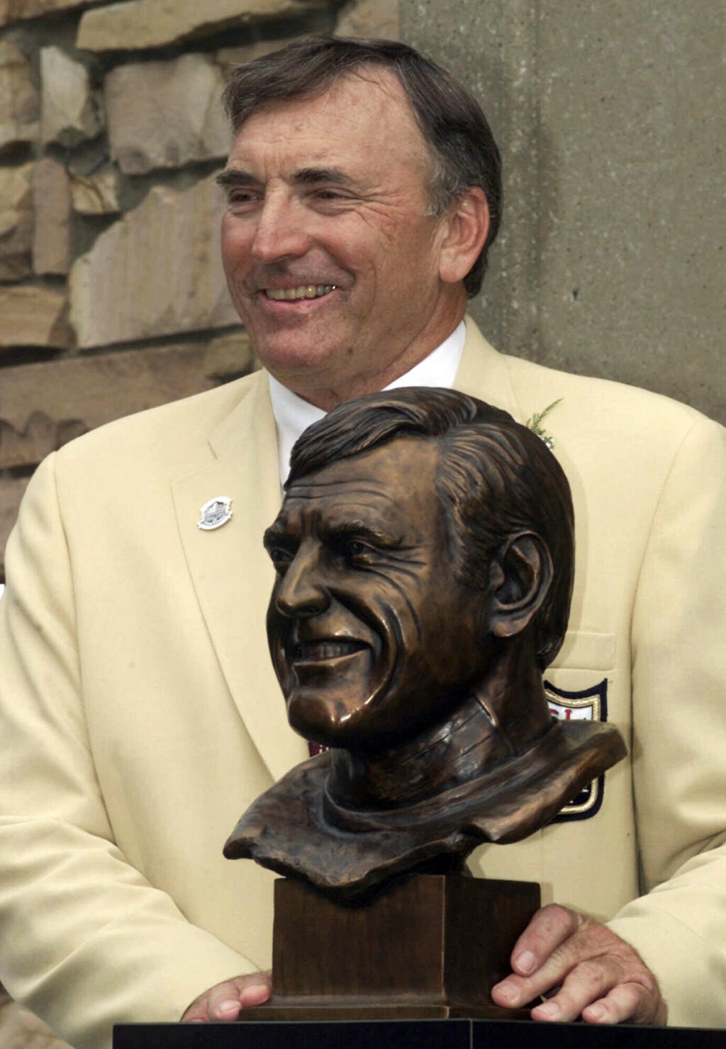 FILE -Former San Francisco 49ers great Dave Wilcox poses with his bust after enshrinement into the Pro Football Hall of Fame Saturday, July 29, 2000, in Canton, Ohio. Hall of Fame linebacker Dave Wilcox, who made the Pro Bowl seven times in his 11 seasons with the San Francisco 49ers, has died. He was 80. The Pro Football Hall of Fame said Wilcox, who is also the father of California football coach Justin Wilcox, died on Wednesday, April 19, 2023. (AP Photo/Mark Duncan, File)