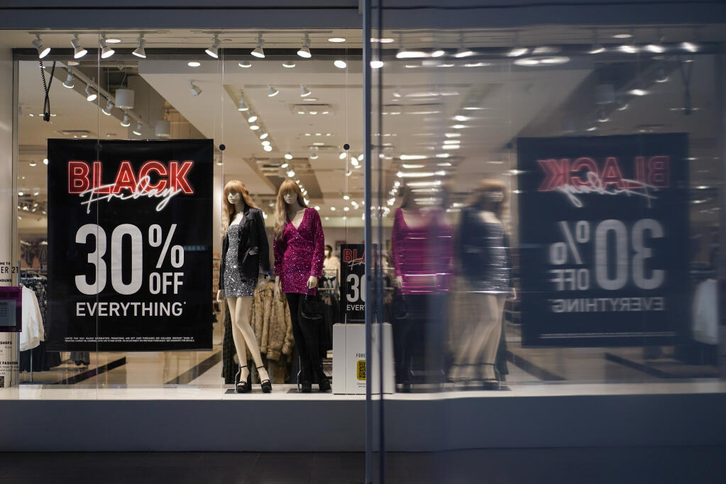Forever 21 posts Black Friday 30% off everything signs in their shop window to draw in Black Friday shoppers at Fashion Centre at Pentagon City in Arlington, Va., Friday, Nov. 25, 2022. (AP Photo/Carolyn Kaster)