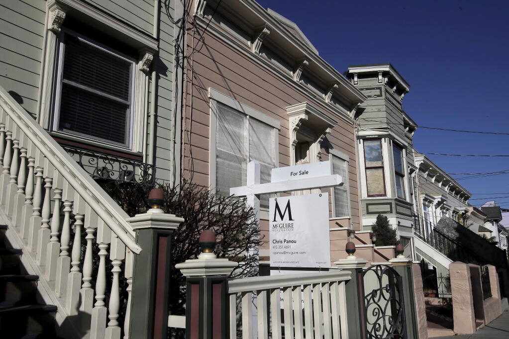 A real estate sign is shown in front of a home for sale in San Francisco on Feb. 18, 2020. (AP Photo/Jeff Chiu, File)