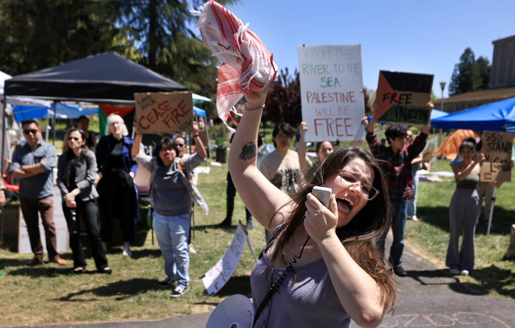 Tammy Jo, a community member from Sonoma County leads a chant during pro-Palestinian protest at Person Lawn at Sonoma State University, Tuesday, April 30, 2024, in Rohnert Park.  (Kent Porter / The Press Democrat)