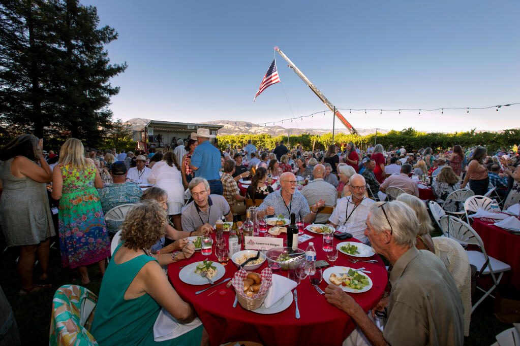 Guests dine during the Wine Country to the Rescue benefit at Trentadue Winery, Saturday July 16, 2022, in Geyserville. (Darryl Bush / For The Press Democrat)