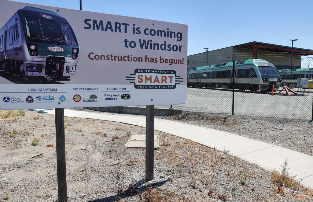 A sign near the SMART facility on Airport Boulevard advertises construction of the rail line to Windsor, in Santa Rosa, Thursday, July 6, 2023. (Christopher Chung / The Press Democrat)