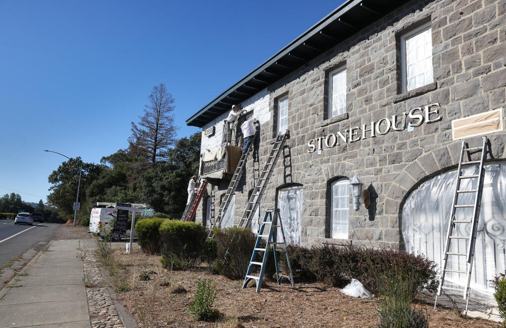 A crew of painters work on covering the Stone House in white paint along Sonoma Highway in Santa Rosa, Tuesday, Oct. 3, 2023. (Christopher Chung / The Press Democrat)
