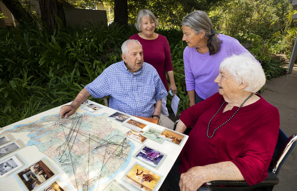 Seated, Bill, 97, and Dorothy Owens, 98, look at a map with their daughters Sue Owens, left, and Cindy Owens-Baird, of the 80 different towns in 13 states where they lived together. The couple will celebrate their 75th wedding anniversary on Monday, May 31, 2021. (Photo by John Burgess/The Press Democrat)