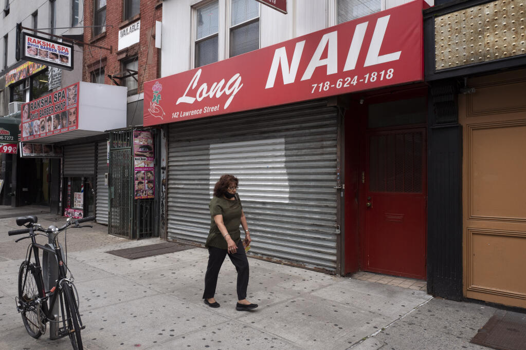 A Brooklyn nail salon remains closed during the coronavirus pandemic, Tuesday, June 30, 2020, in New York. New York City may begin Phase 3 reopening as early as Monday, July 6 which will allow nail salons to reopen. (AP Photo/Mark Lennihan)