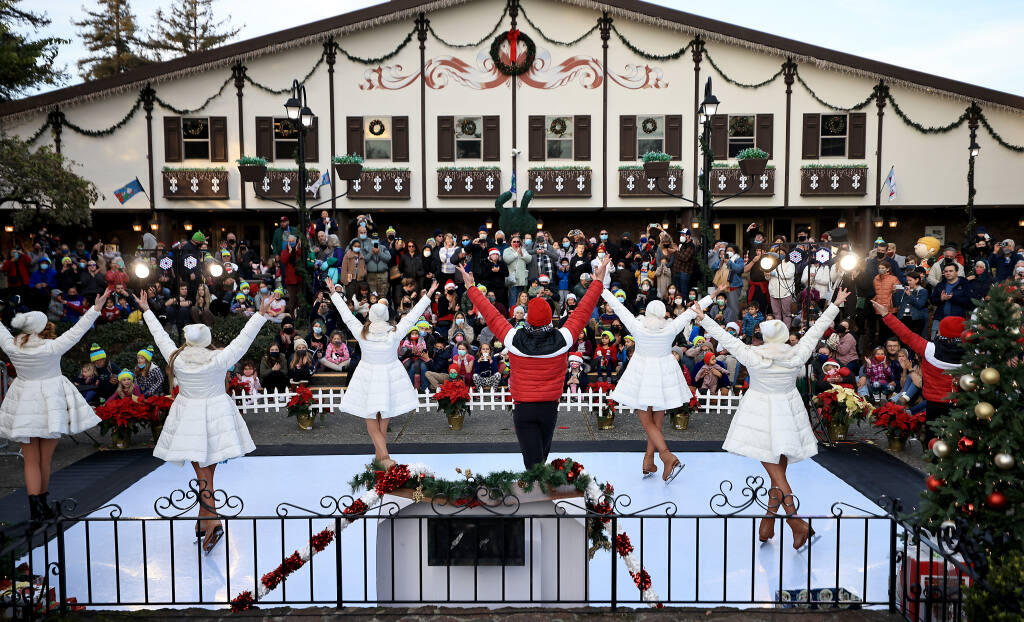 Ice skaters with the Redwood Ice Theatre Company entertain a crowd of several hundred people in December 2021 outside Snoopy’s Home Ice in Santa Rosa. (Kent Porter / The Press Democrat file)