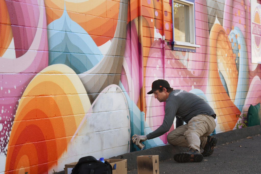 Ricky Watts, a Sebastopol-based artist, working on the final touches of his mural on Tia Maria Panaderia y Pasteleria on Sebastopol Road during The Mural Festival in Roseland neighborhood of Santa Rosa, Monday, June 27, 2022. (Erik Castro / For The Press Democrat file)