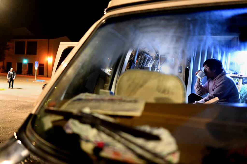 Student Caleb Chen eats noodles for dinner in his van in parking lot G11 at Cal Poly Humboldt. (Wally Skalij/Los Angeles Times/TNS)