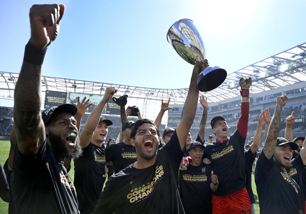 Los Angeles FC forward Carlos Vela holds up the cup after defeating Austin FC in Major League Soccer’s Western Conference final Sunday in Los Angeles. (John McCoy / ASSOCIATED PRESS)