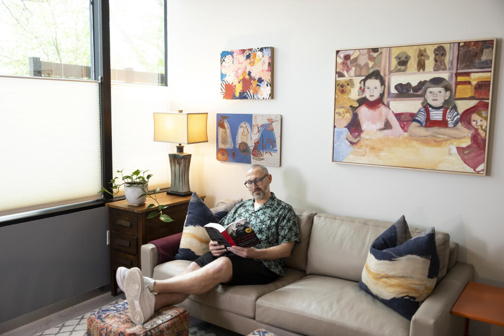 Eduardo Lerro, a former public school teacher who recently became a higher-paid consultant and moved back to the Minneapolis area, reads in his condo’s office, in Minnetonka, Minn., May 9, 2023. Educated workers are increasingly migrating away from the country’s most expensive major metros — and have been since before the pandemic. (Jenn Ackerman/The New York Times)