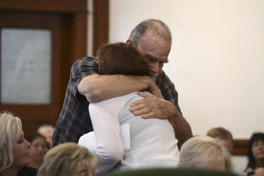 Kay and Larry Woodcock, the grandparents of JJ Vallow, embrace each other after Lori gave her victim impact statement during the sentencing hearing of Lori Vallow Daybell at the Fremont County Courthouse in St. Anthony, Idaho, Monday, July 31, 2023. Idaho mother Vallow Daybell has been sentenced to life in prison without parole Monday in the murders of her two youngest children and a romantic rival in a case that included bizarre claims that her son and daughter were zombies and that she was a goddess sent to usher in the Biblical apocalypse. (Tony Blakeslee/EastIdahoNews.com via AP, Pool)