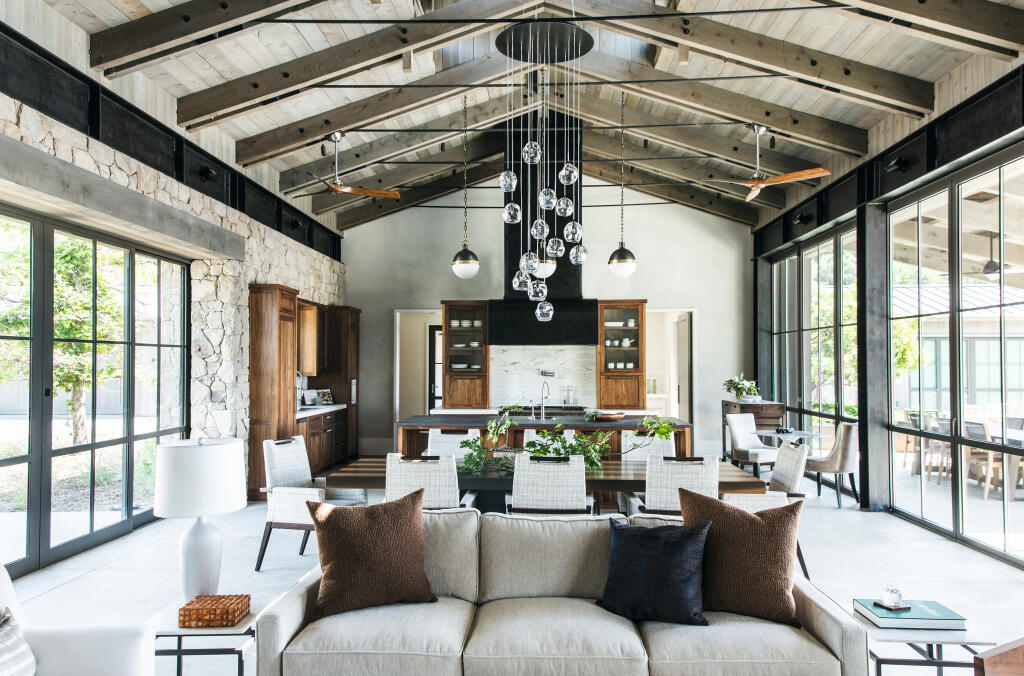 This open plan living room in Sonoma by architect Michael Guthrie lets the landscape and light in from both sides. (Aubrie Pick/ Marion Brenner Photography).