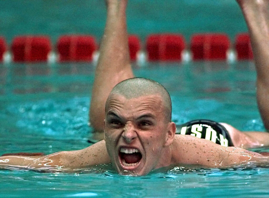 FILE - In this July 24, 1996, file photo, Scott Miller of Australia shows his disappointment after finishing in silver medal place in the men's 100 meter butterfly final at the 1996 Summer Olympics in Atlanta. Miller was in custody on Tuesday, Feb. 16, 2021, charged with drug trafficking after Australian police seized methamphetamine valued at 2 million Australian dollars ($1.6 million) and accused him of directing a criminal syndicate. (AP Photo/Hans Deryk, File)