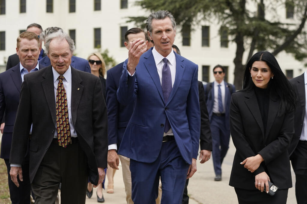 California Gov. Gavin Newsom, center, tours the campus of the Veterans Affairs of Greater Los Angeles on Friday, May 26, 2023, in Los Angeles. (AP Photo/Ashley Landis, Pool)