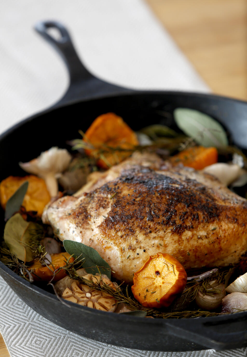 Hassle-free turkey breasts, shown here roasted with aromatics in a skillet, have been popular for Thanksgiving dinner during the pandemic. (Beth Schlanker/ The Press Democrat)