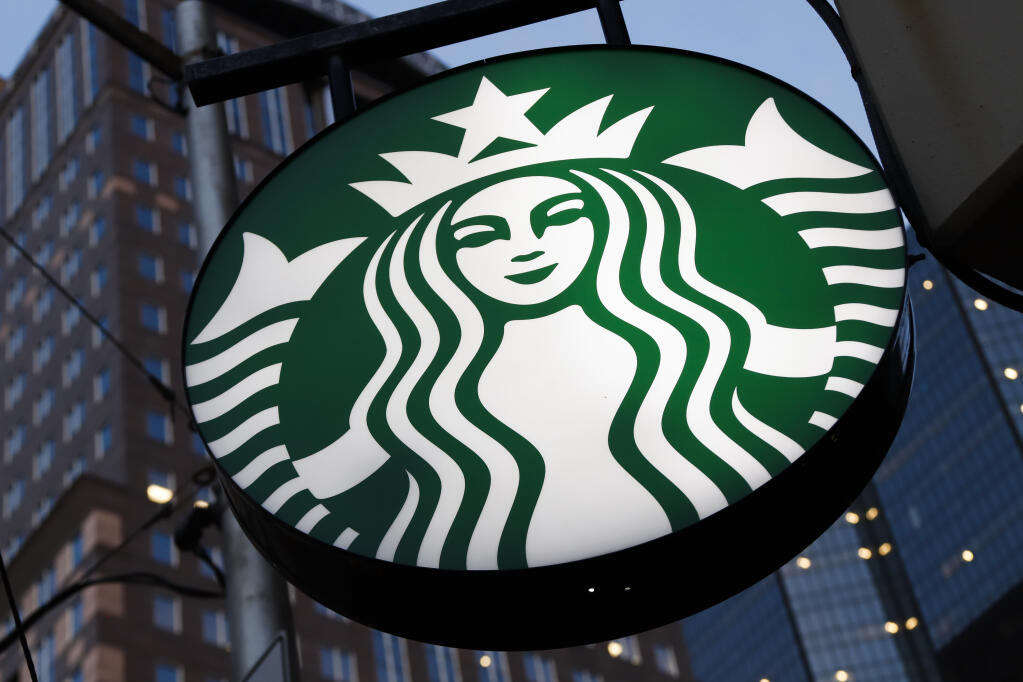 FILE — A Starbucks sign hangs outside a Starbucks coffee shop in downtown Pittsburgh on June 26, 2019. The coffee giant said Thursday, Sept. 1, 2022, that longtime PepsiCo executive Laxman Narasimhan will join Starbucks on Oct. 1, after relocating from London to Seattle, where Starbucks is based. (AP Photo/Gene J. Puskar, File)