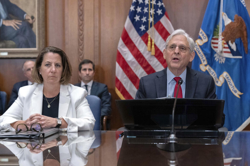 FILE - Attorney General Merrick Garland accompanied by Deputy Attorney General Lisa Monaco speaks during a meeting at Department of Justice in Washington, June 14, 2023. Hundreds of people have been charged with the theft of more than $830 million in COVID-19 emergency aid following a nationwide operation conducted by federal, state and local law enforcement agencies, the U.S. Justice Department announced Wednesday. (AP Photo/Jose Luis Magana, File)
