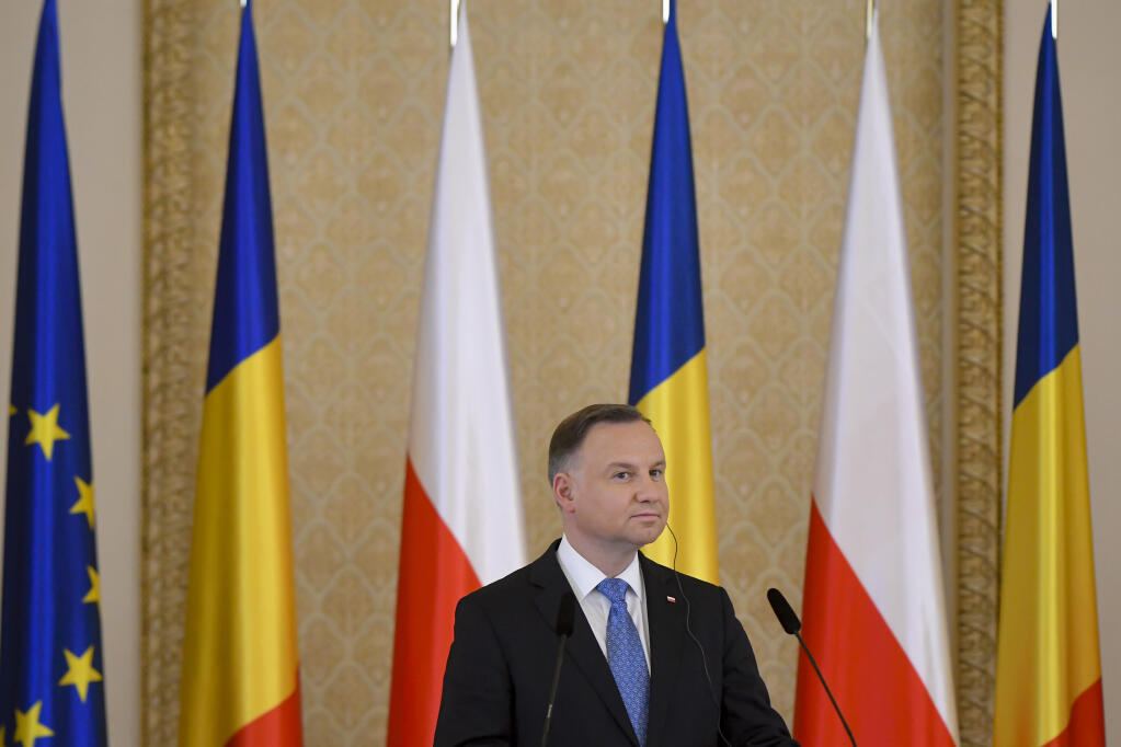 Poland's President Andrzej Duda listens to Romania's President Klaus Iohannis during press statements at the Presidential Palace in Bucharest, Romania, Tuesday, March 22, 2022. (AP Photo/Andreea Alexandru)