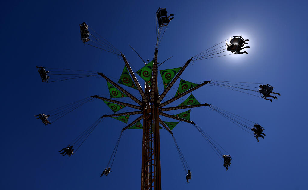 Sonoma County Fair patrons get a view of the heavens on the Vertigo carnival ride, Wednesday, Aug. 9, 2023, in Santa Rosa. (Kent Porter / The Press Democrat)