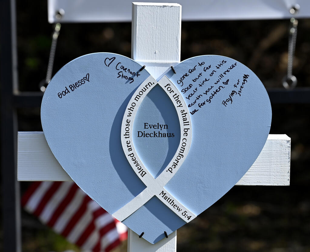 A victim's name and a heart are on each of the six crosses built by members of the Lutheran Church Charities from Chicago and placed at a makeshift memorial by the entrance of the Covenant School, Tuesday, March 28, 2023, in Nashville, Tenn. (Mark Zaleski/The Tennessean via AP)