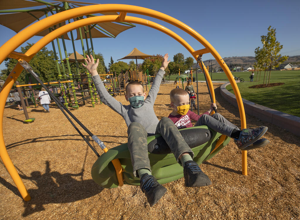 Daniel, 8, and Konrad Damron, 7, were among the first kids to play in the newly opened Coffey Neighborhood Park on Wednesday, Oct. 28, 2020. The brothers, who live across the street, have waited for their park to open for three years since the Tubbs fire burned the old park. (John Burgess / The Press Democrat)