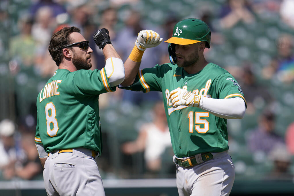 The Athletics’ Seth Brown, right, celebrates his two-run home run with Jed Lowrie against the Tigers in the eighth inning in Detroit on Thursday, May 12, 2022. (Paul Sancya / ASSOCIATED PRESS)