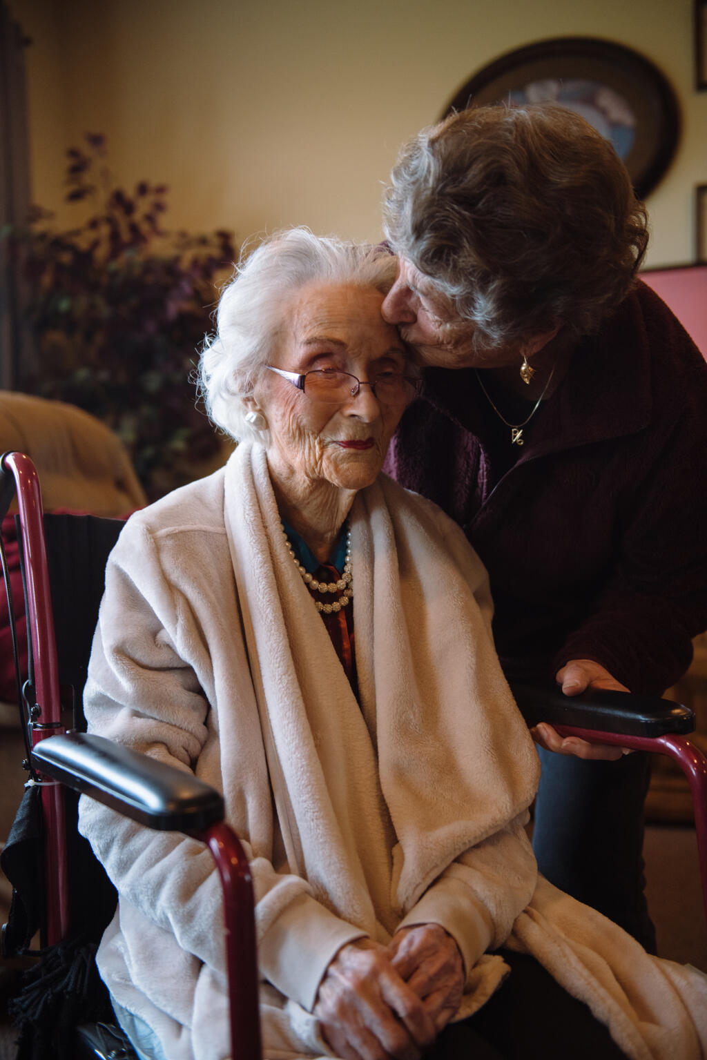 Evelyn Persico, 84, right, spends time with Edith Ceccarelli the day before her 116th birthday, at Holy Spirit Residential Care Home in Willits, Calif., Feb. 4, 2024. When the nation’s oldest person has a birthday, a California community makes sure to celebrate. (Alexandra Hootnick/The New York Times)