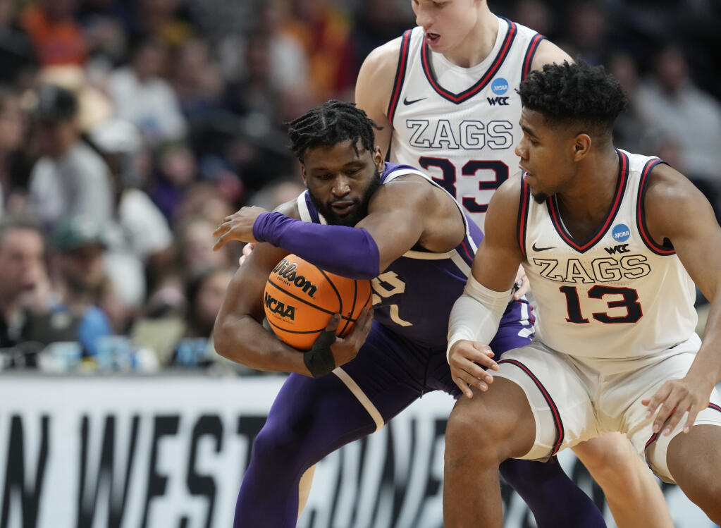 TCU guard Mike Miles Jr., left, protects the ball as Gonzaga guard Malachi Smith defends in the second half of a second-round college basketball game in the men's NCAA Tournament Sunday, March 19, 2023, in Denver. (AP Photo/David Zalubowski)