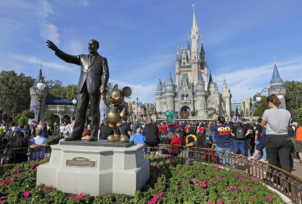 A statue of Walt Disney and Micky Mouse stands in front of the Cinderella Castle at the Magic Kingdom at Walt Disney World in Lake Buena Vista, Fla., Jan. 9, 2019. Florida Gov. Ron DeSantis’ oversight board of Disney World has voted to claw back authority over the company’s theme park properties. The vote Wednesday, April 26, 2023, by the governor’s appointees voids a last-minute deal that placed control of theme park design and construction decisions Disney’s hands. (AP Photo/John Raoux, File)