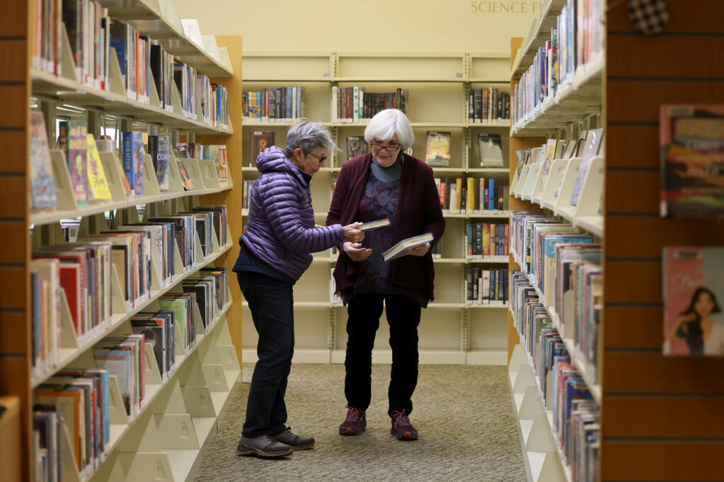 Librarian Kate McBride, right, helps Janet Gaffney find some books at the public library in St. Helena, Wednesday, March 27, 2024. (Beth Schlanker / The Press Democrat)