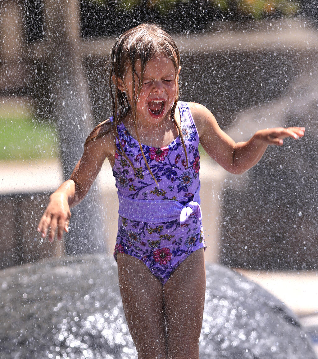 Riley Moore, 5, plays in the fountain at the Rohnert Park Community Center in Rohnert Park, Tuesday, July 11, 2023. (Kent Porter / The Press Democrat)