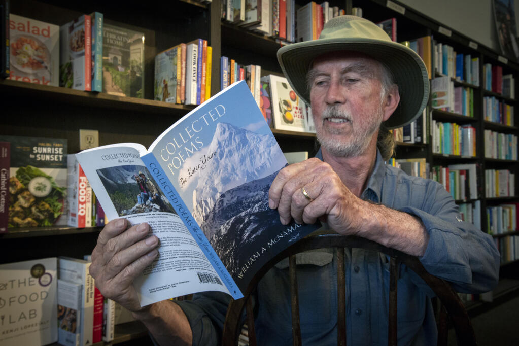 Bill McNamara flips through his newest book’ “Collected Poems, The Later Years,” at Readers’ Books on East Napa Street on Tuesday, Aug. 16, 2022. (Robbi Pengelly/Index-Tribune)