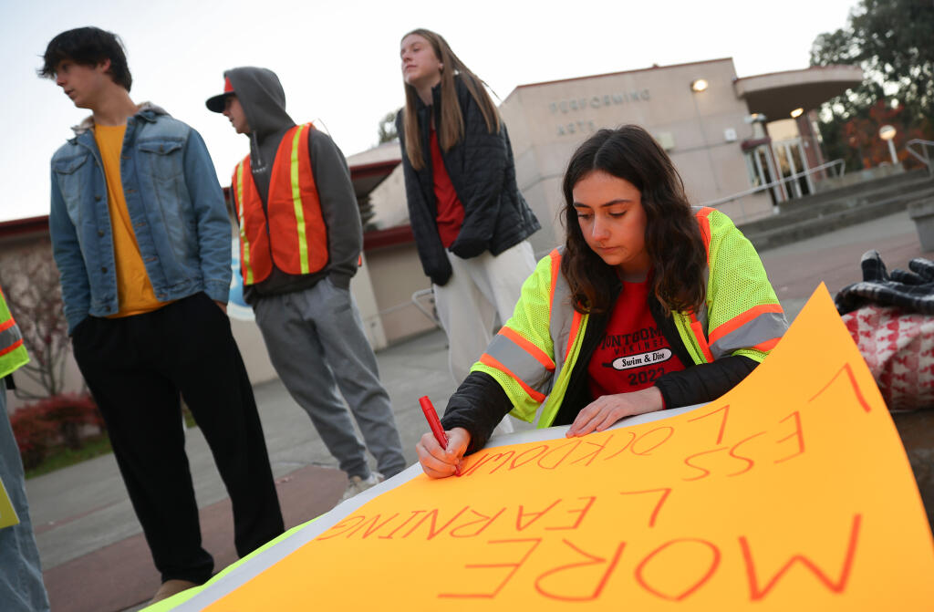Zoey Cook makes a sign for the demonstration over school safety concerns at Montgomery High School in Santa Rosa on Monday, Dec. 11, 2023. (Christopher Chung/The Press Democrat)