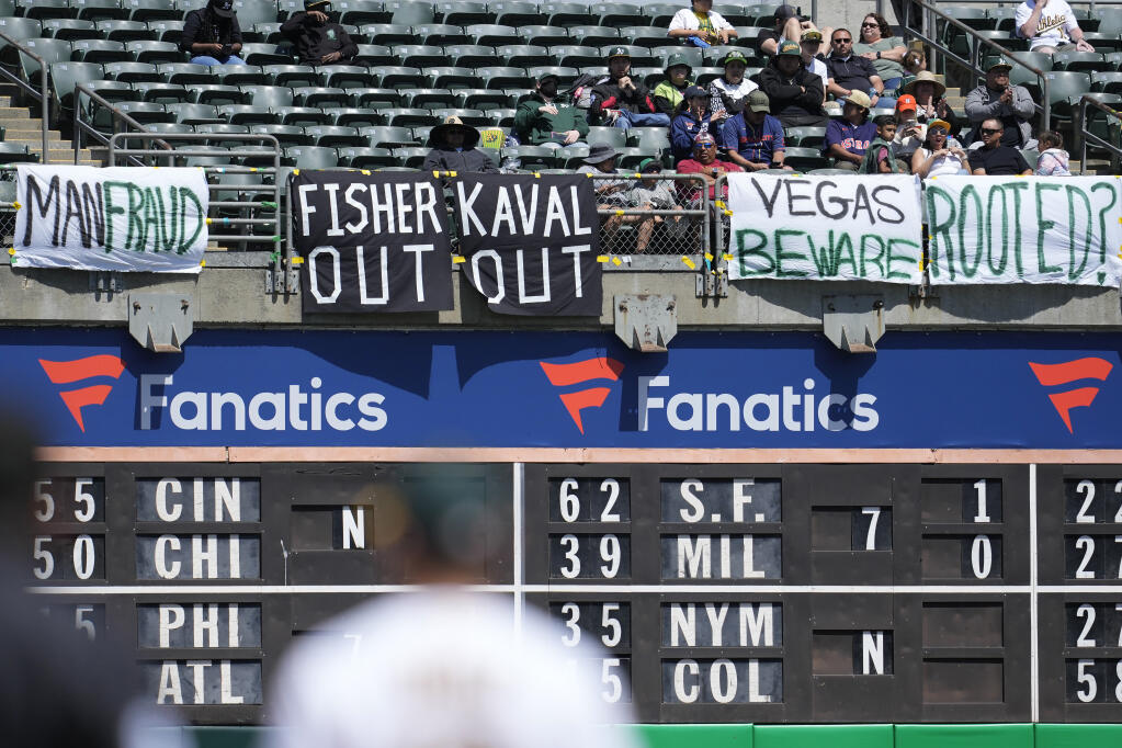 Oakland Athletics fans display their views about the team’s planned move to Las Vegas. (JEFF CHIU / Associated Press)