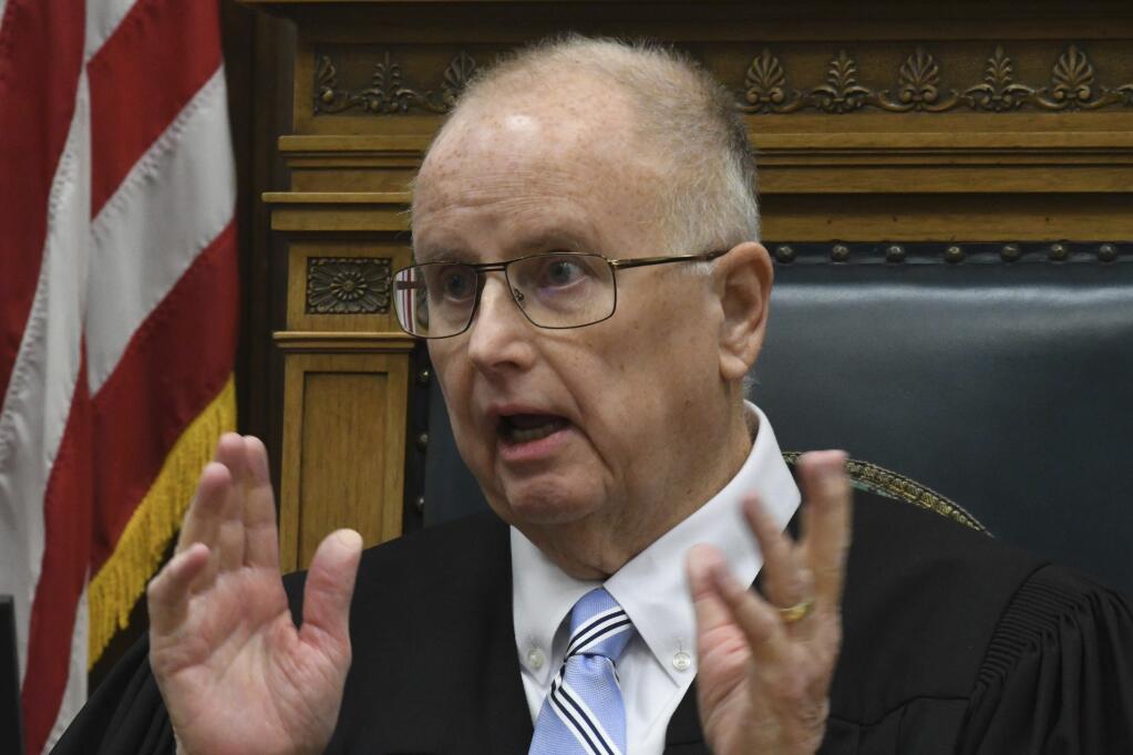 Judge Bruce Schroeder talks about the juror who attempted to tell a joke to a bailiff during Kyle Rittenhouse's trial at the Kenosha County Courthouse in Kenosha, Wis., on Thursday, Nov. 4, 2021. The juror, known as Juror No. 7, was removed due to the incident. Rittenhouse is accused of killing two people and wounding a third during a protest over police brutality in Kenosha, last year. (Mark Hertzberg /Pool Photo via AP)