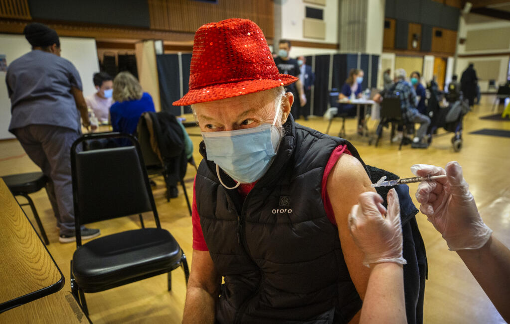 Raphael Wolf, 75, of Sebastopol, receives his first COVID-19 vaccination shot at a clinic for seniors over 75 years old at the Rohnert Park Community Center on Wednesday, Jan. 27, 2021.  (John Burgess/The Press Democrat)