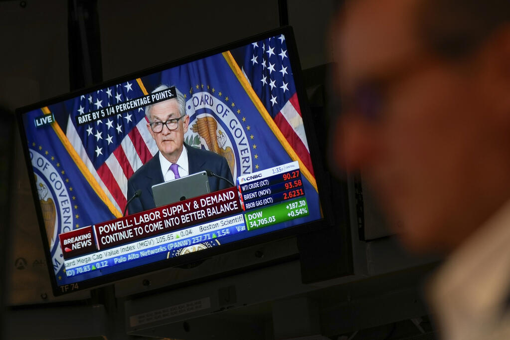 A press conference by Federal Reserve chairman Jerome Powell is displayed on the floor at the New York Stock Exchange in New York, Wednesday, Sept. 20, 2023. The Federal Reserve left its key interest rate unchanged for the second time in its past three meetings, a sign that it's moderating its fight against inflation as price pressures have eased. (AP Photo/Seth Wenig)
