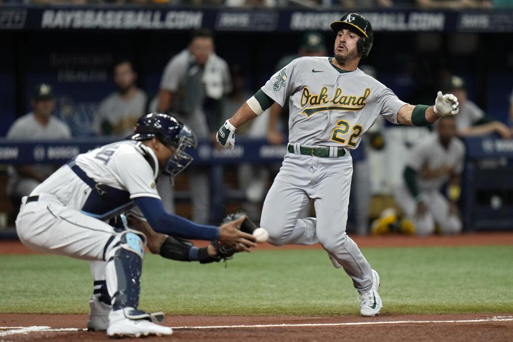 The A’s Ramon Laureano prepares to get tagged out at home plate by Rays catcher Christian Bethancourt while trying to score on an RBI single by Jace Peterson during the second inning Friday in St. Petersburg, Florida. (Chris O’Meara / ASSOCIATED PRESS)